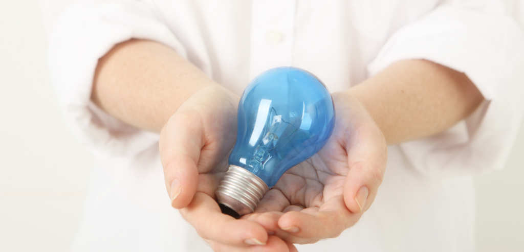 blue-light-bulb-in-hands