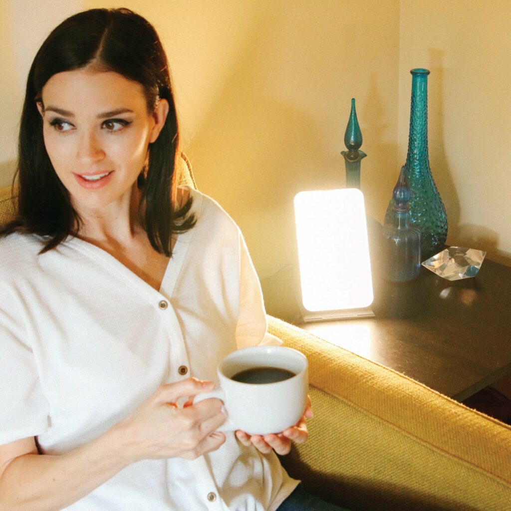 woman-having-coffee-next-to-SAD-lamp