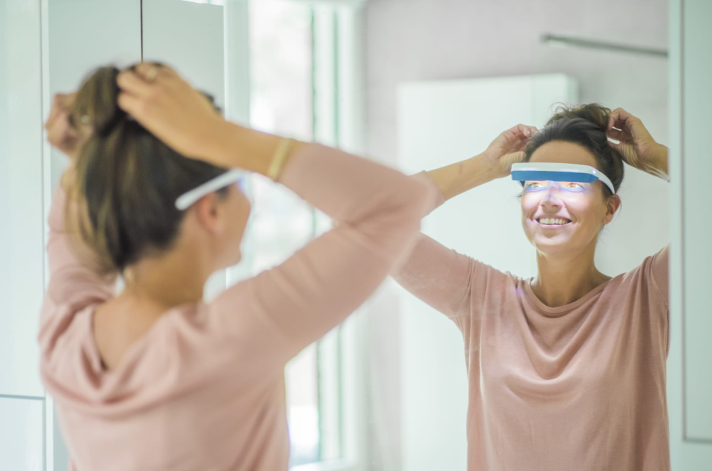 woman-fixing-hair-light-therapy-glasses
